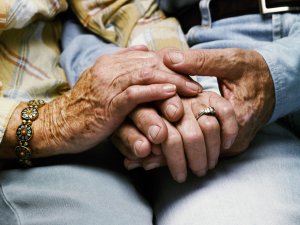 Senior couple holding hands, close up